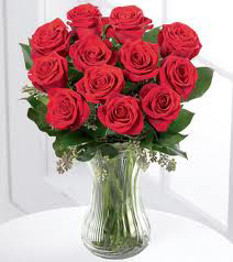 Dozen red roses in glass vase